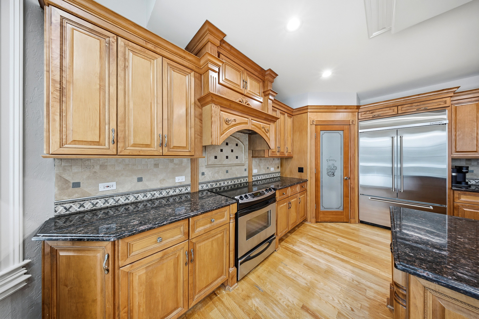 761 Reserve Court South Elgin, IL 60177 - Photo 22 of 89 a kitchen with stainless steel appliances granite countertop a stove a sink and a refrigerator