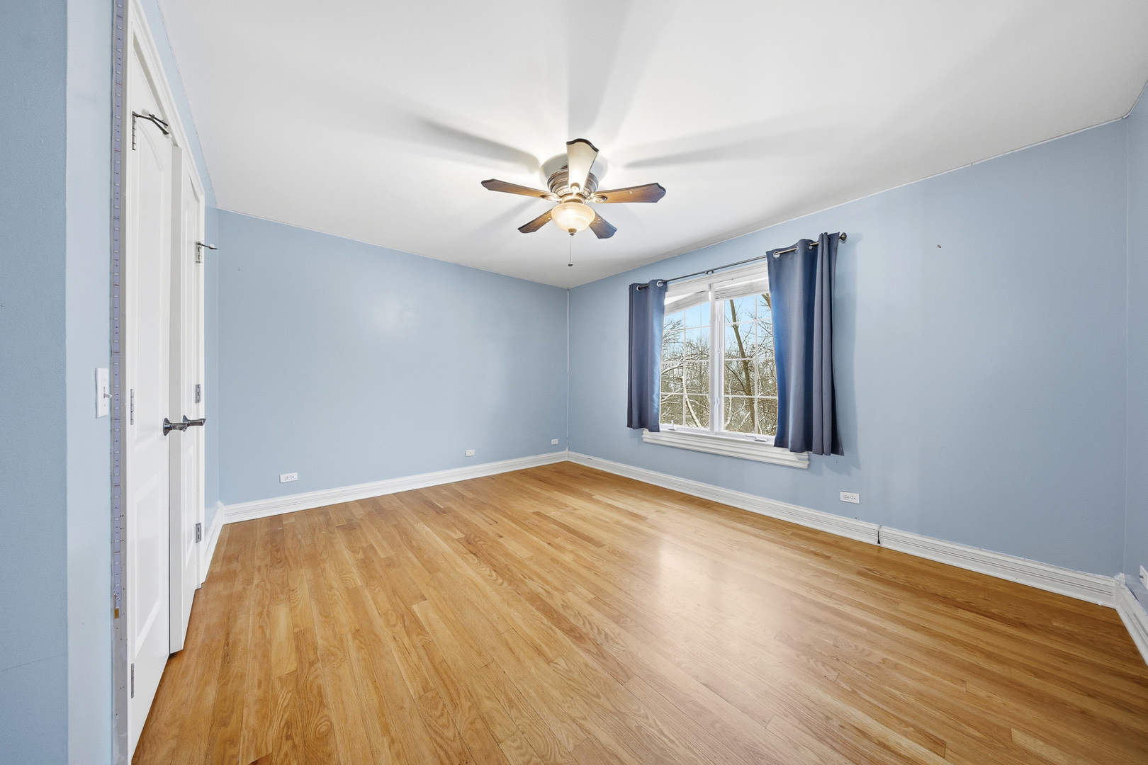 761 Reserve Court South Elgin, IL 60177 - Photo 52 of 89 a view of empty room with wooden floor and fan