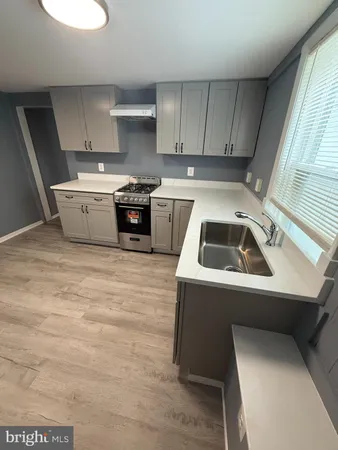 a kitchen that has a sink and a stove