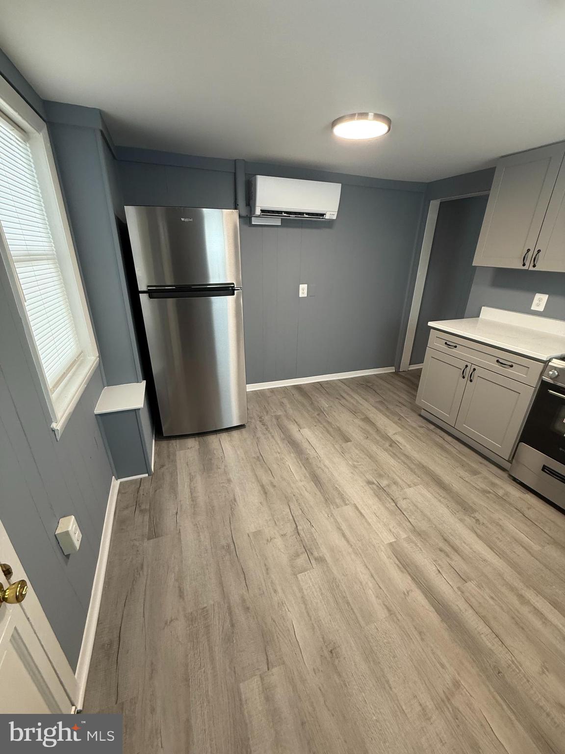122 West All Saints Street Frederick, MD 21701 - Photo 13 of 23 a view of empty room with wooden floor and electronic appliances
