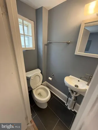 a white toilet sitting next to a bathroom sink