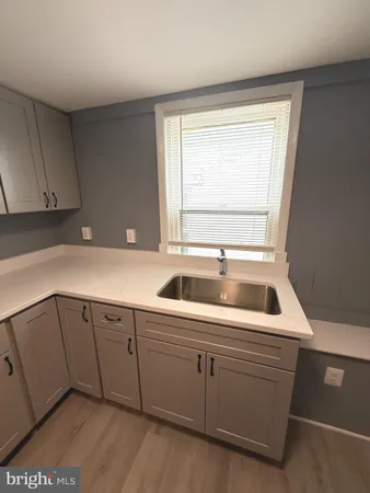 a kitchen with a sink and cabinets