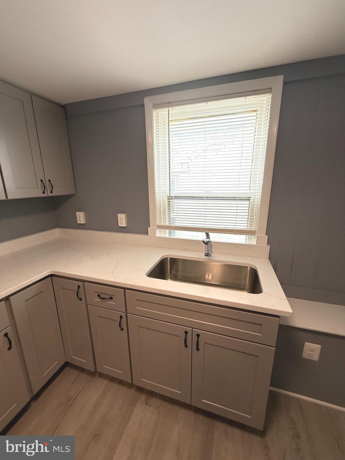 122 West All Saints Street Frederick, MD 21701 - Photo 10 of 23 a kitchen with a sink and cabinets