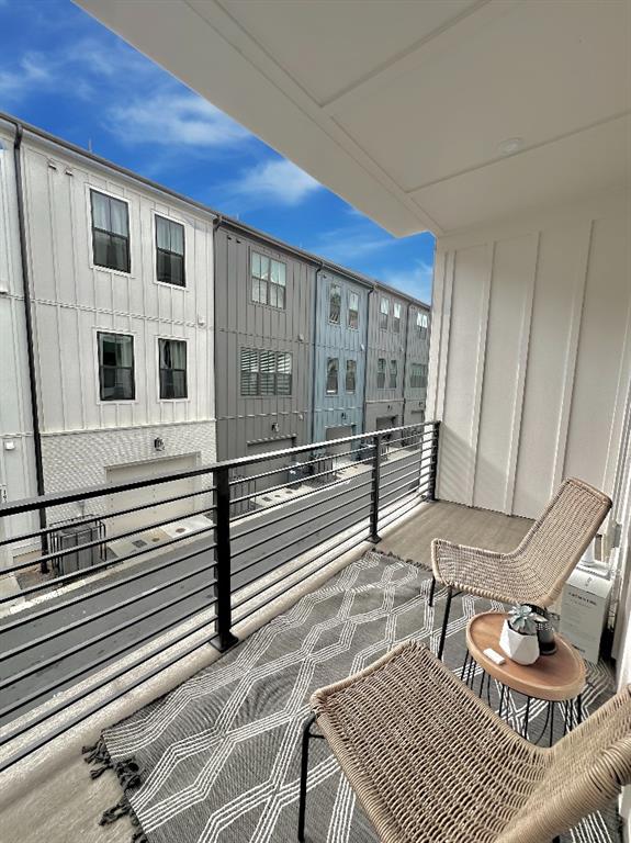192 Chestnut Circle Atlanta, GA 30342 - Photo 13 of 16 a view of a balcony with wooden floor and iron stairs