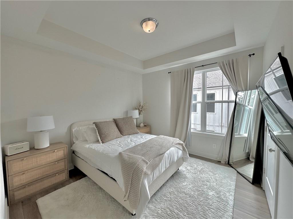 192 Chestnut Circle Atlanta, GA 30342 - Photo 7 of 16 a bedroom with a bed toilet and a large window