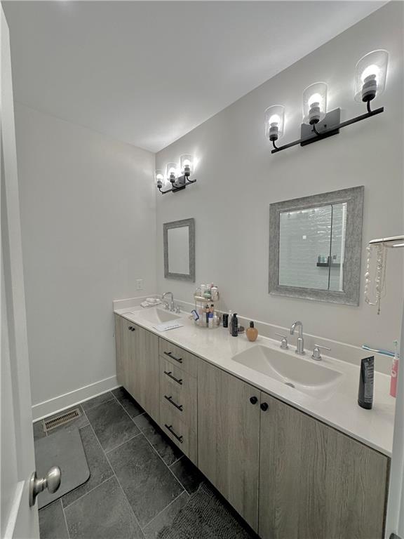 192 Chestnut Circle Atlanta, GA 30342 - Photo 8 of 16 a bathroom with double sink and a mirror