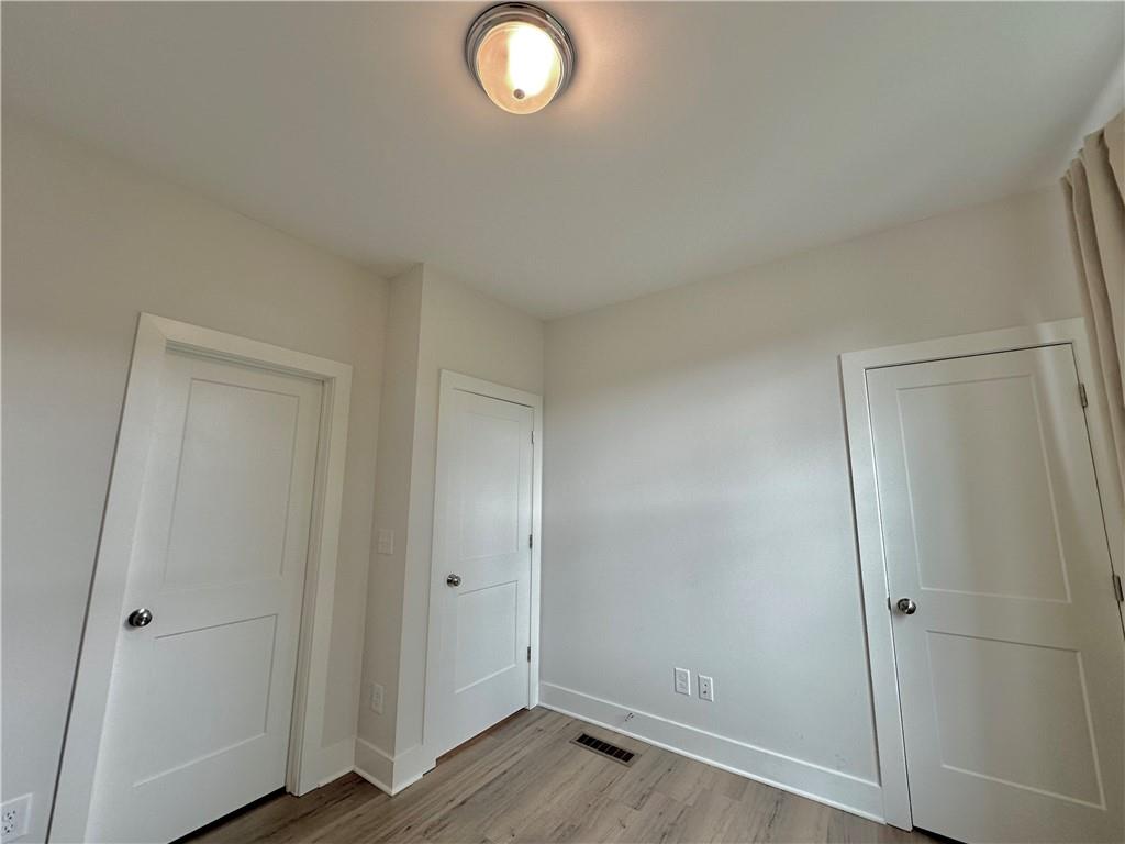 192 Chestnut Circle Atlanta, GA 30342 - Photo 10 of 16 an empty room with wooden floor and window