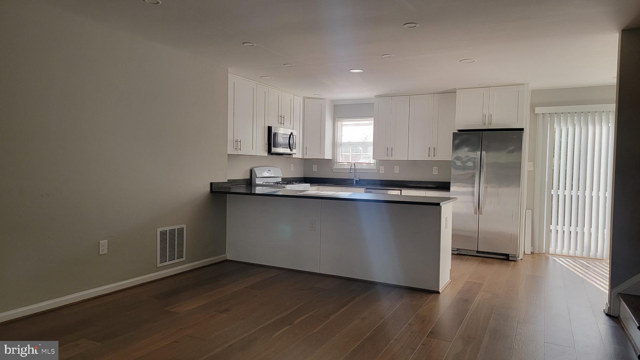 6110 George Baylor Drive Centreville, VA 20121 - Photo 2 of 12 a kitchen with granite countertop a refrigerator and a sink