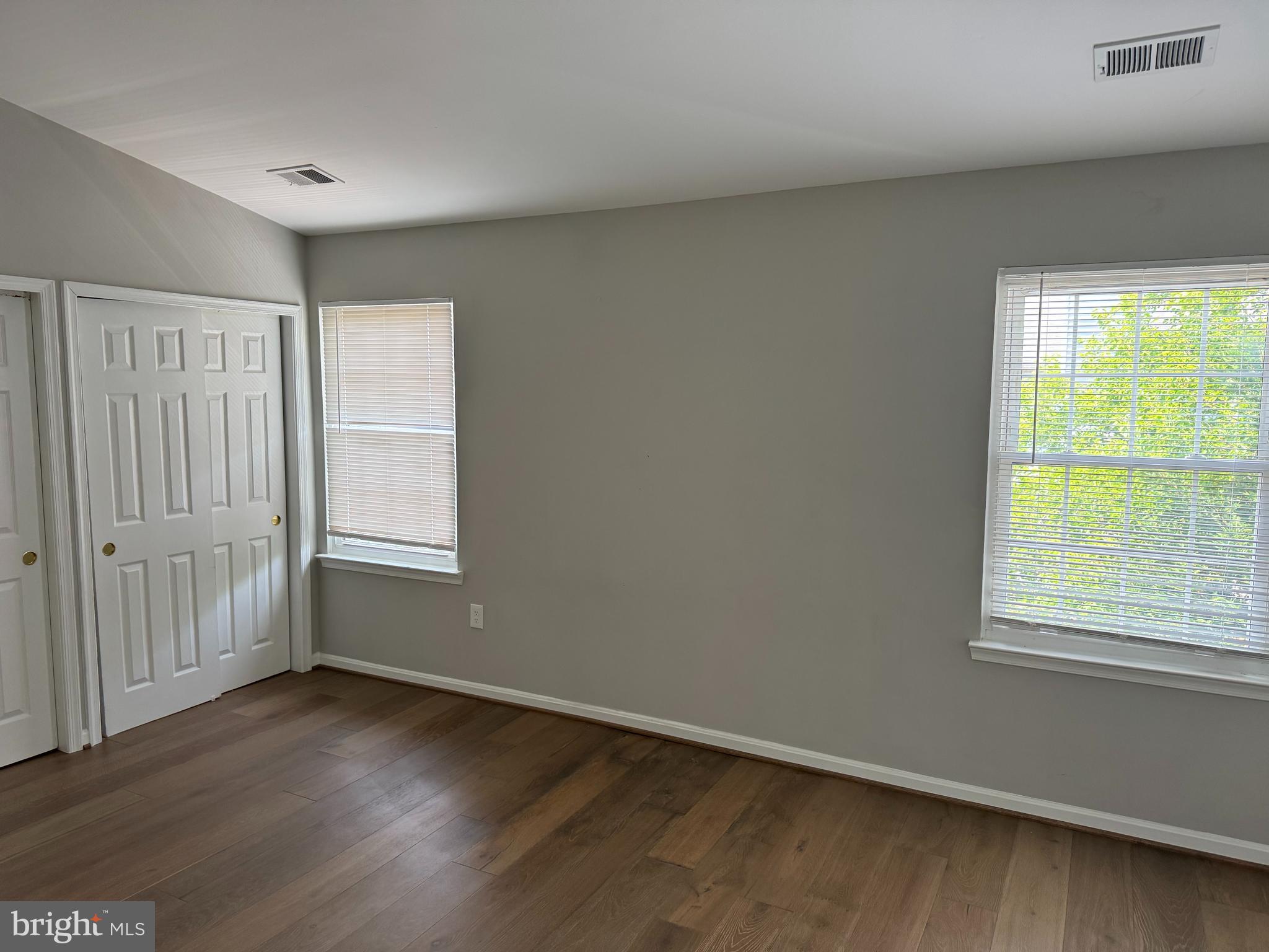 6110 George Baylor Drive Centreville, VA 20121 - Photo 5 of 12 an empty room with wooden floor and windows