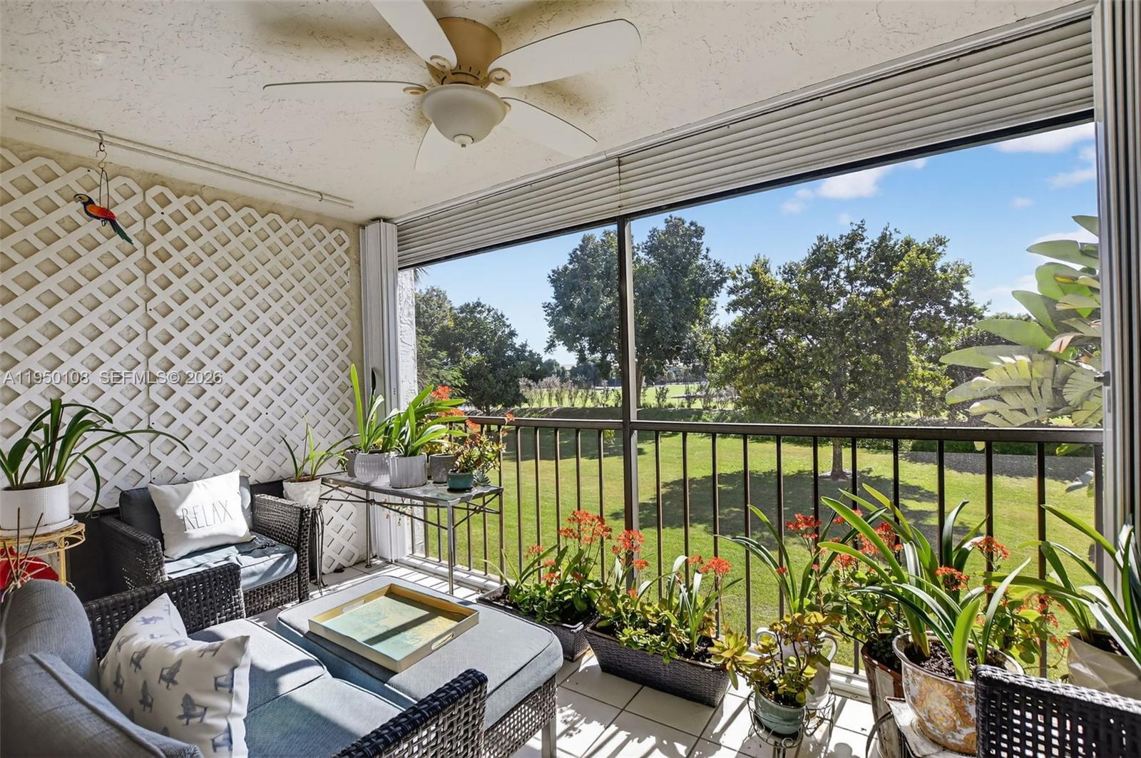 6530 Boca Del Mar Drive, Unit 235 Boca Raton, FL 33433 - Photo 11 of 34 a living room with patio furniture and a potted plant