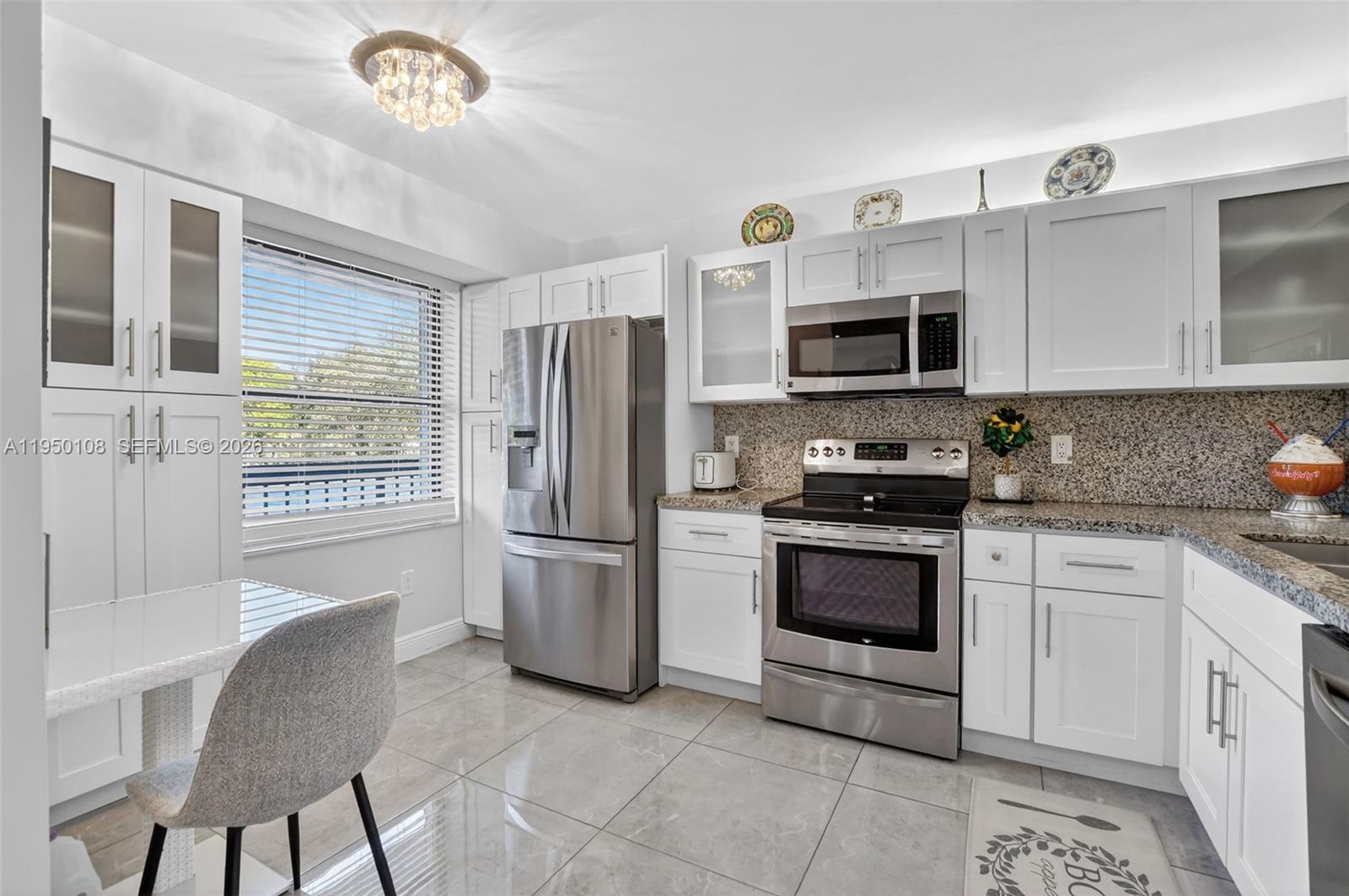 6530 Boca Del Mar Drive, Unit 235 Boca Raton, FL 33433 - Photo 2 of 34 a kitchen with stainless steel appliances granite countertop a refrigerator stove and microwave