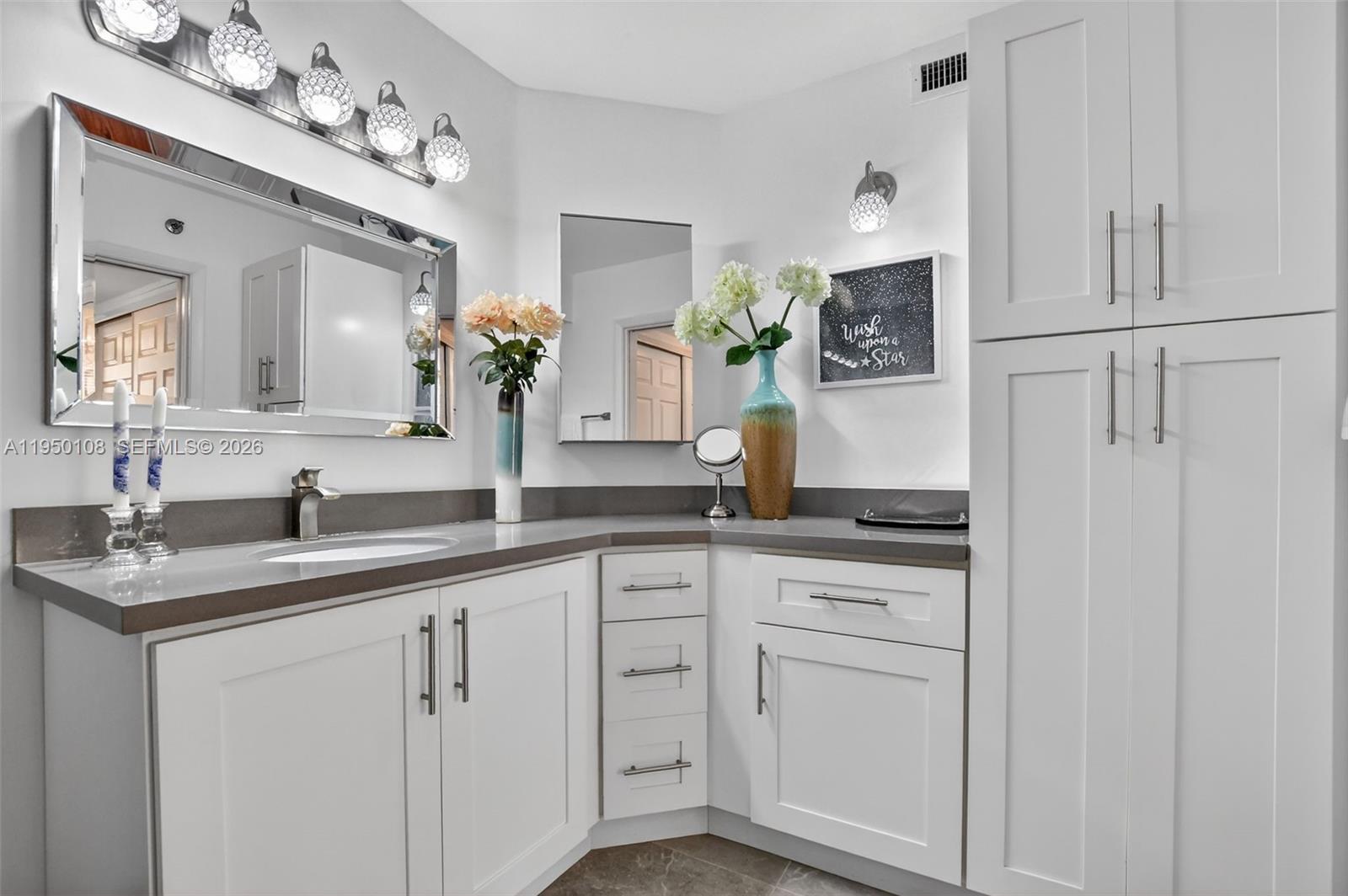 6530 Boca Del Mar Drive, Unit 235 Boca Raton, FL 33433 - Photo 24 of 34 a bathroom with white cabinets and a sink