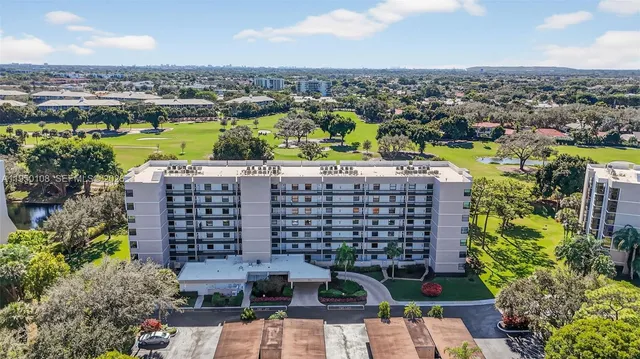 an aerial view of a city with lawn chairs and large trees