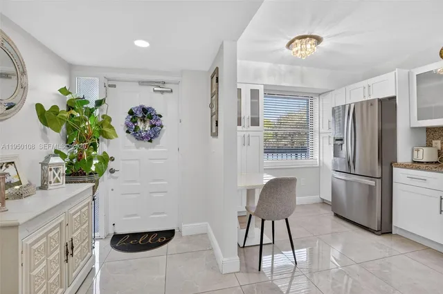 a kitchen with stainless steel appliances kitchen island granite countertop a refrigerator and a stove