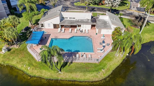 an aerial view of a house with a swimming pool