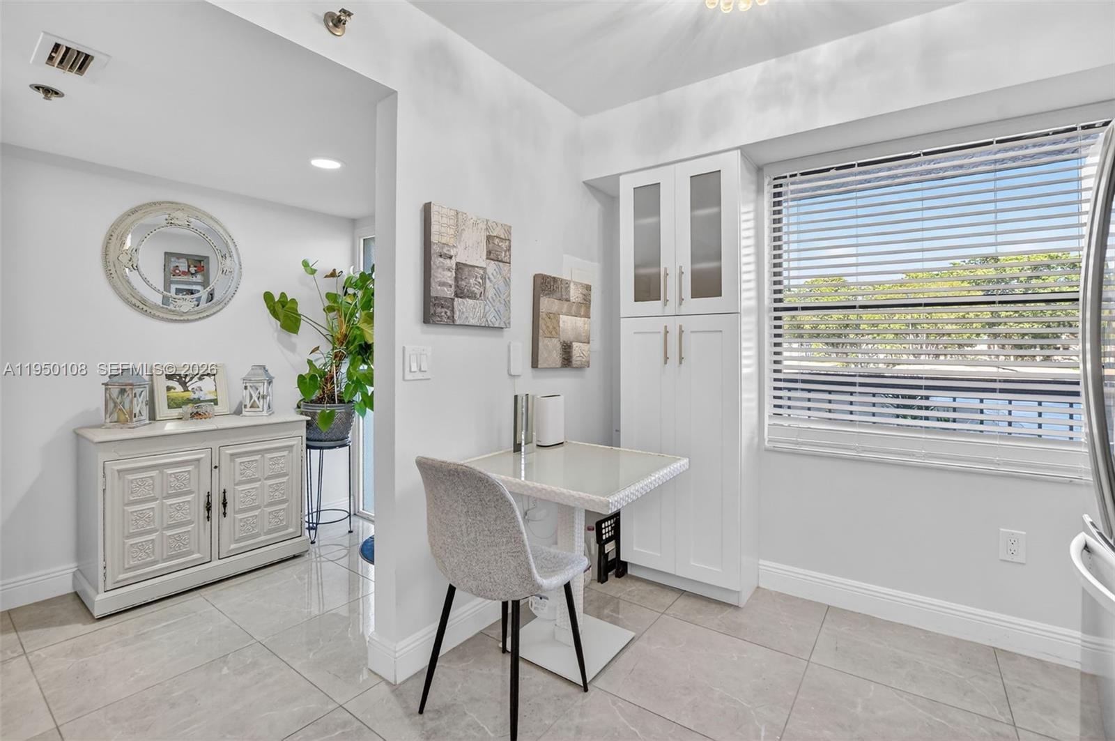 6530 Boca Del Mar Drive, Unit 235 Boca Raton, FL 33433 - Photo 4 of 34 a kitchen with a table and chairs