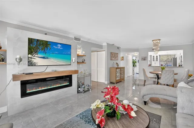 a living room with furniture and flowers