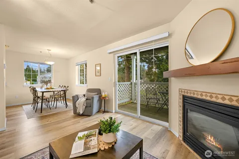 a living room with furniture a table and a fireplace