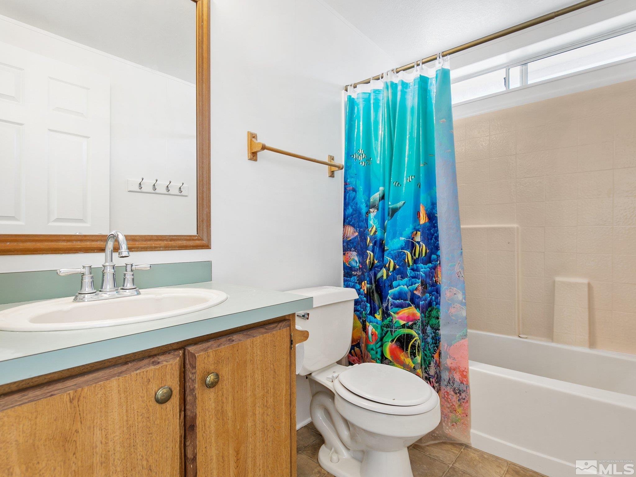17280 Whippoorwill Lane Reno, NV 89508 - Photo 11 of 26 a bathroom with a sink a toilet and a mirror