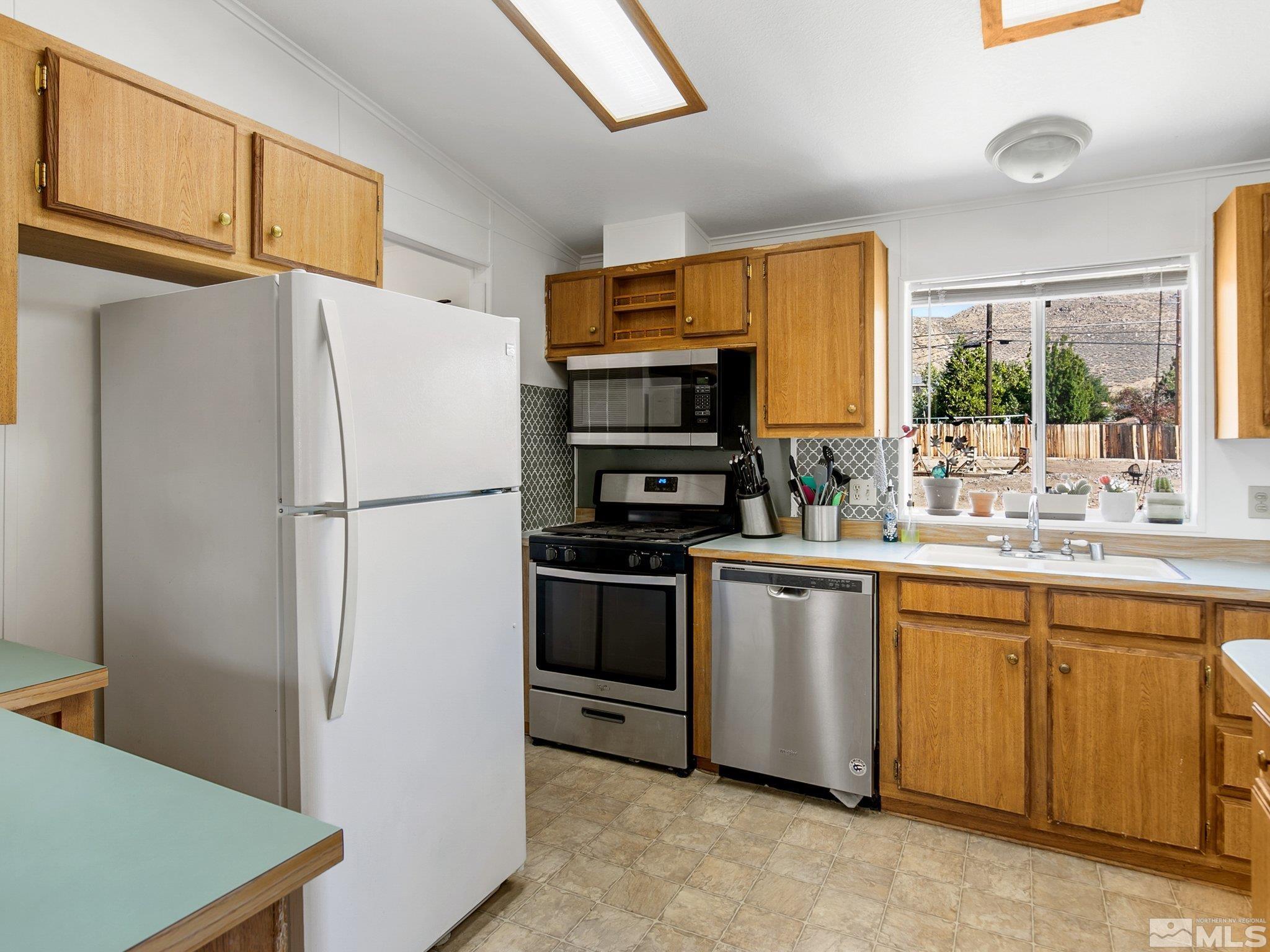 17280 Whippoorwill Lane Reno, NV 89508 - Photo 15 of 26 a kitchen with stainless steel appliances a refrigerator sink and microwave