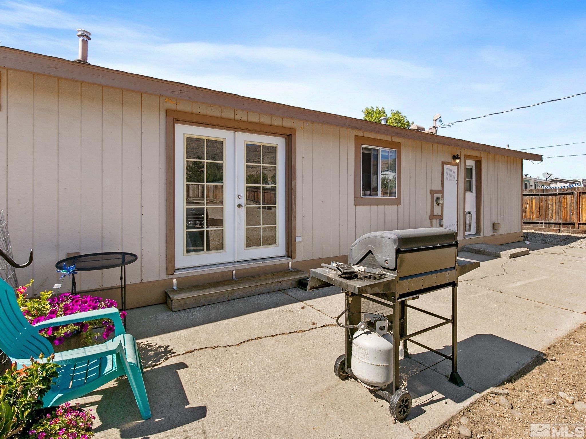 17280 Whippoorwill Lane Reno, NV 89508 - Photo 16 of 26 a table and chairs in front of a house