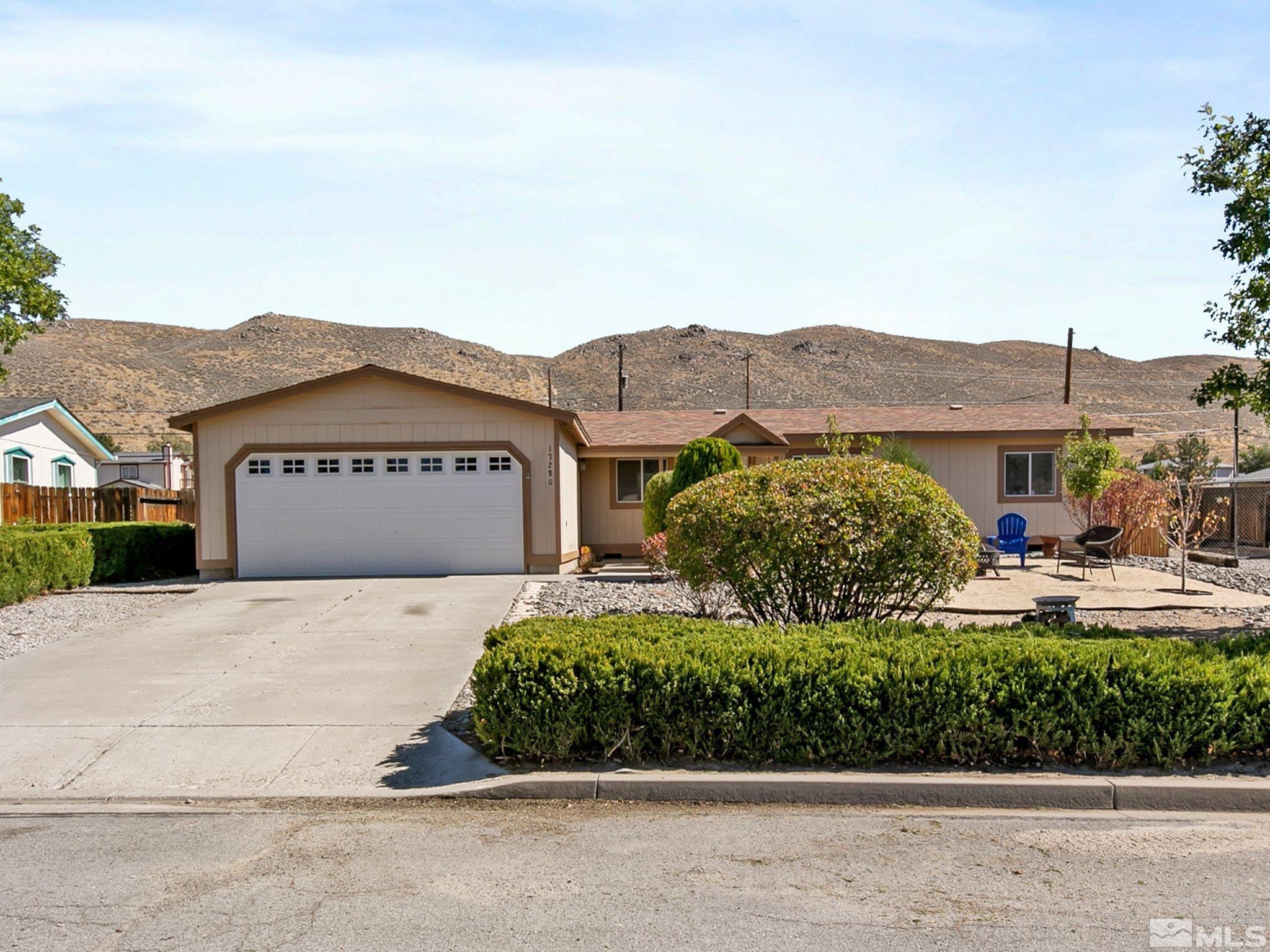 17280 Whippoorwill Lane Reno, NV 89508 - Photo 2 of 26 a front view of a house with a yard and garage