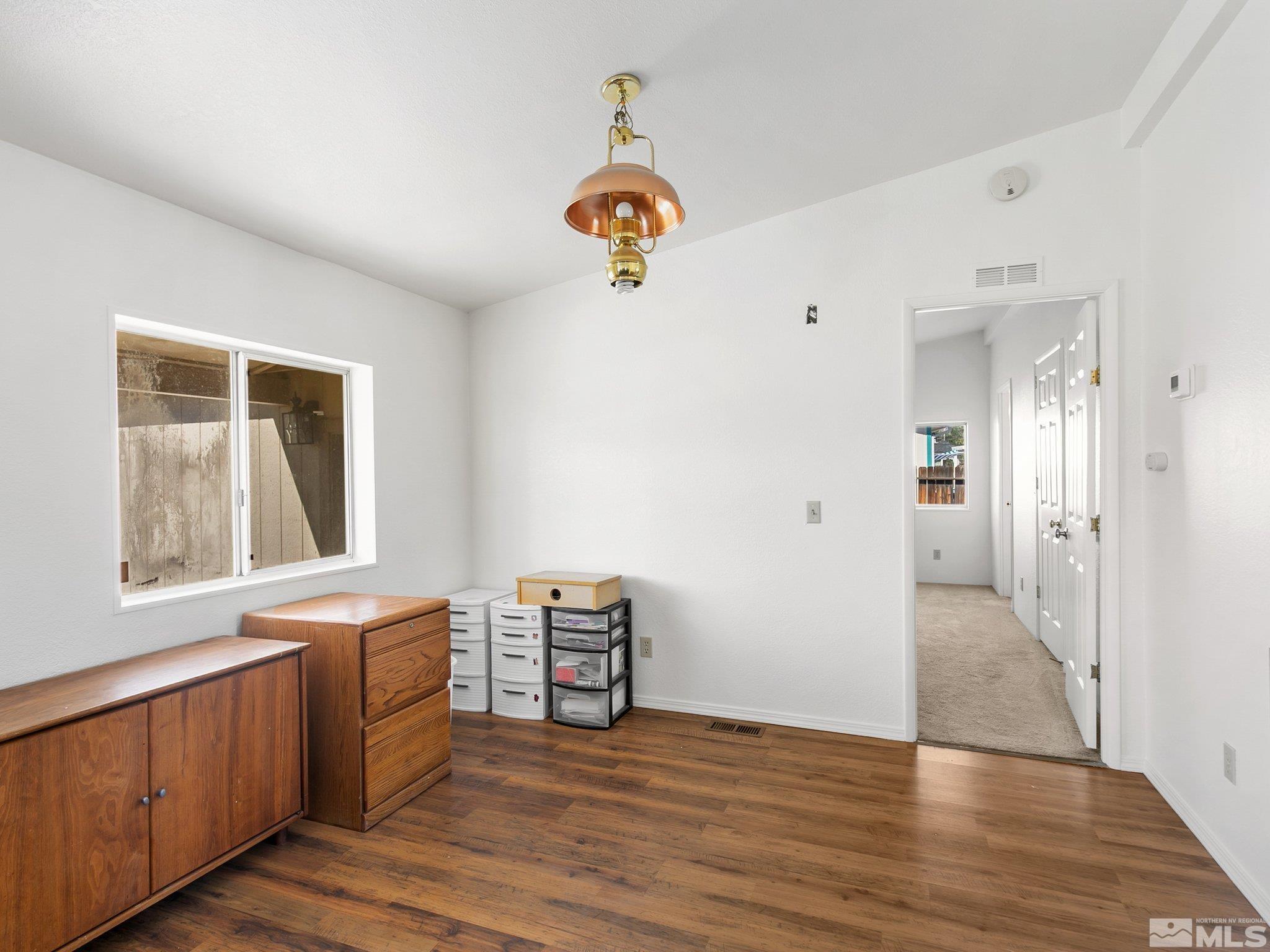 17280 Whippoorwill Lane Reno, NV 89508 - Photo 6 of 26 a view of an empty room with window and wooden floor