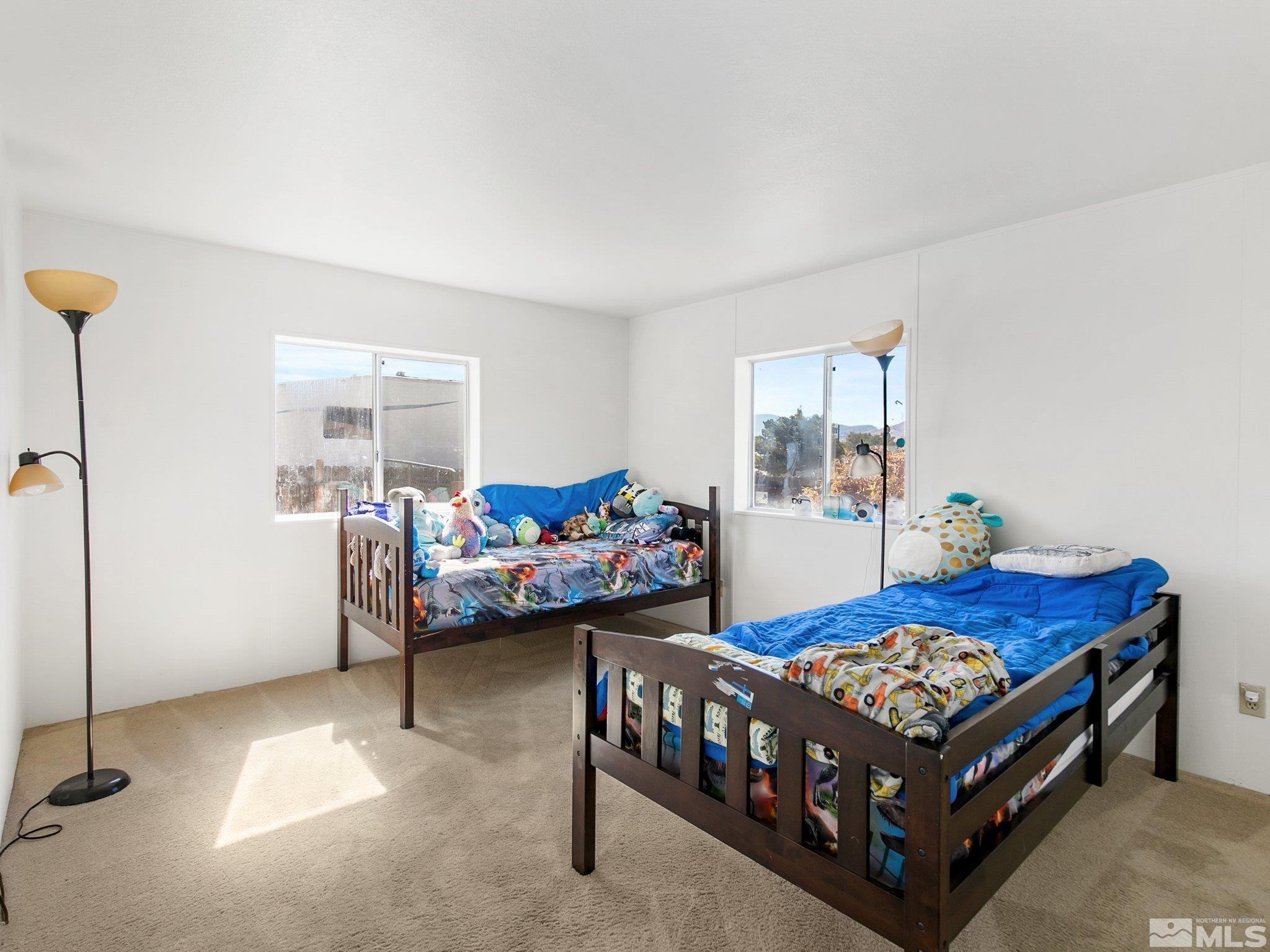 17280 Whippoorwill Lane Reno, NV 89508 - Photo 10 of 26 a bedroom with a bed and a table in it