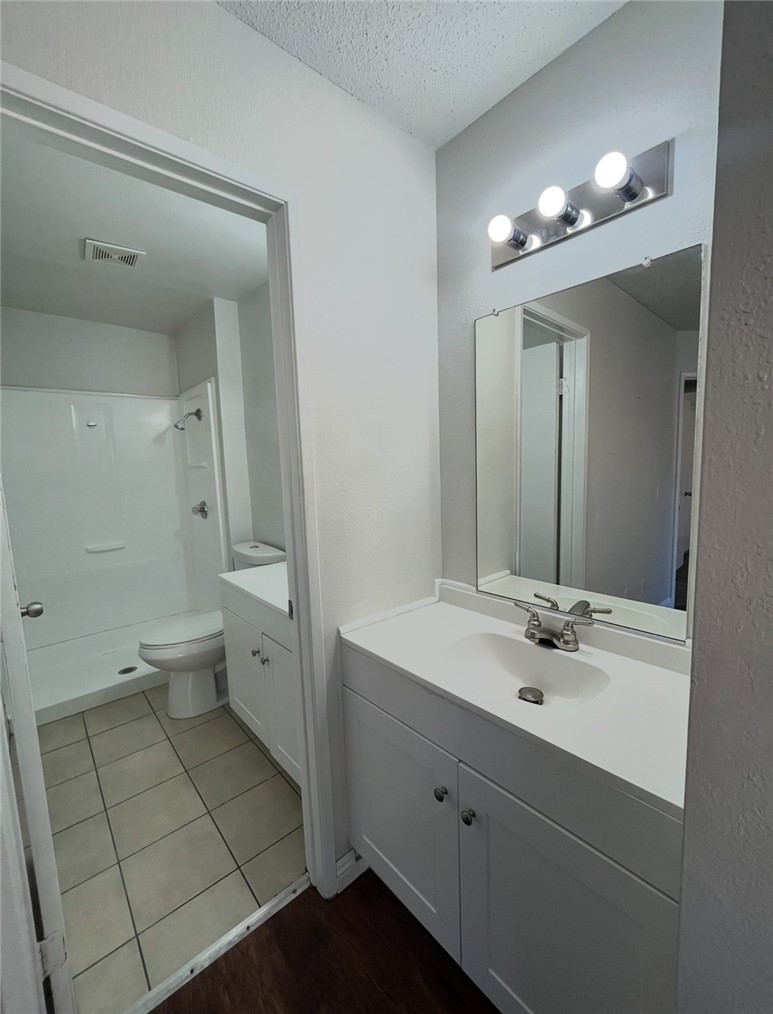 1025 North Tippecanoe, Unit 151 San Bernardino, CA 92410 - Photo 6 of 11 a spacious bathroom with a double vanity sink toilet and a mirror