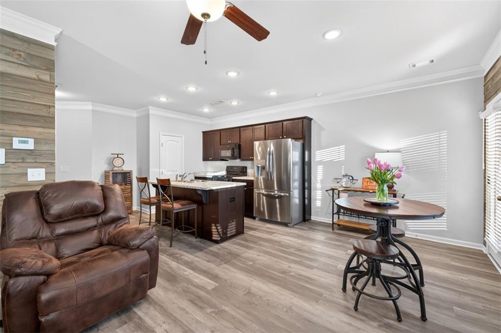 286 Turtle Creek Drive Winder, GA 30680 - Photo 12 of 39 a living room with furniture kitchen area and a wooden floor