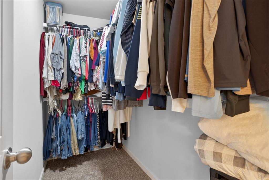 286 Turtle Creek Drive Winder, GA 30680 - Photo 23 of 39 a view of walk in closet with clothes and shoes