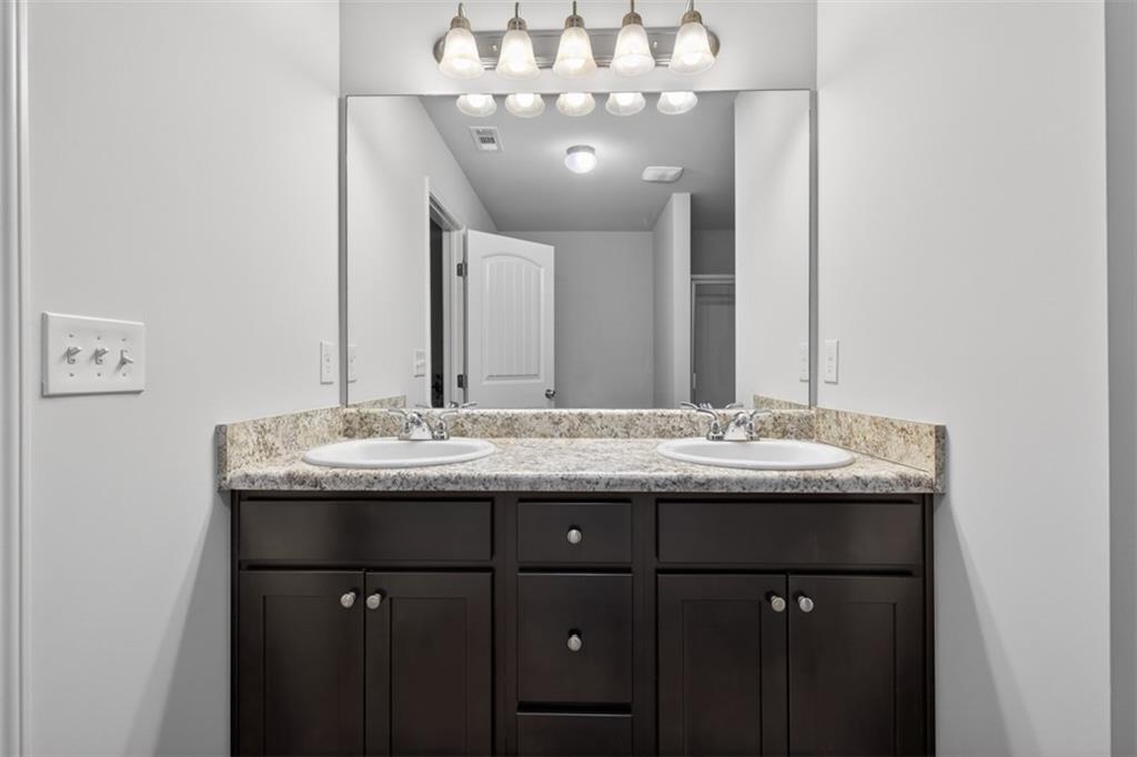 286 Turtle Creek Drive Winder, GA 30680 - Photo 24 of 39 a bathroom with a granite countertop sink and a mirror