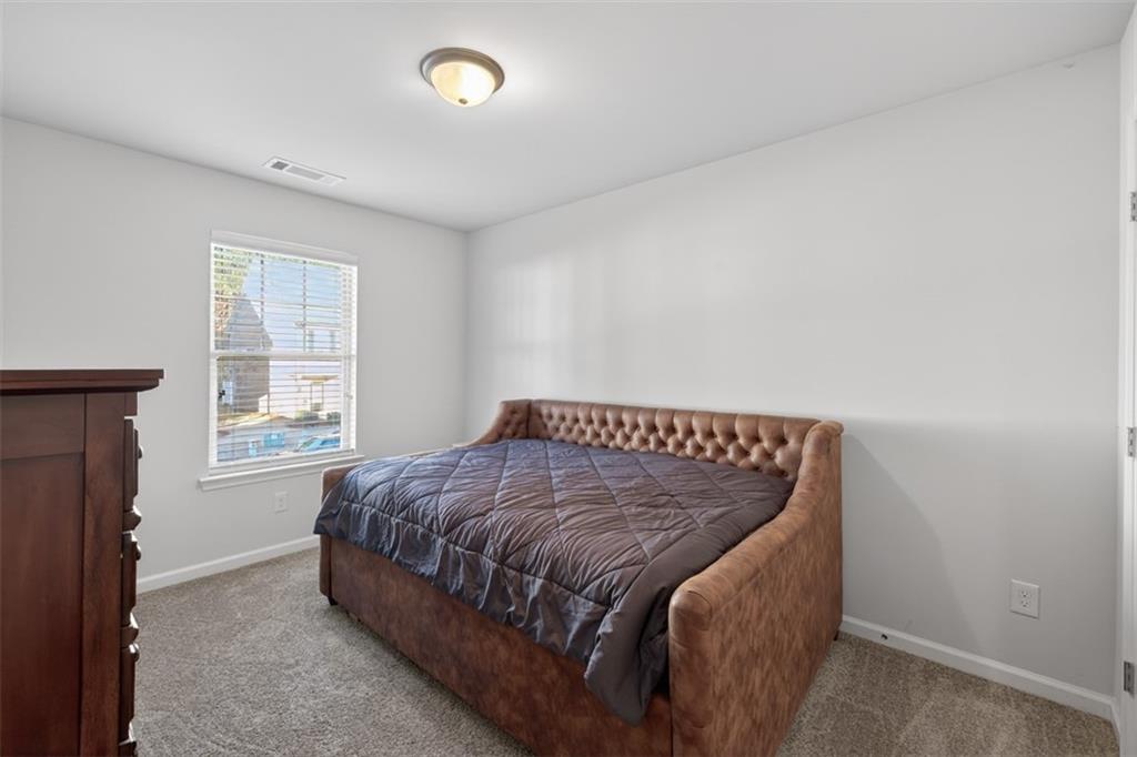 286 Turtle Creek Drive Winder, GA 30680 - Photo 30 of 39 a bed sitting in a bedroom next to a window