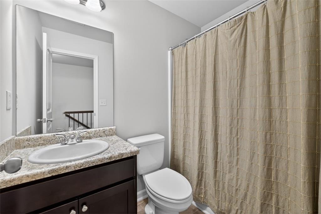 286 Turtle Creek Drive Winder, GA 30680 - Photo 32 of 39 a bathroom with a granite countertop sink toilet and a mirror
