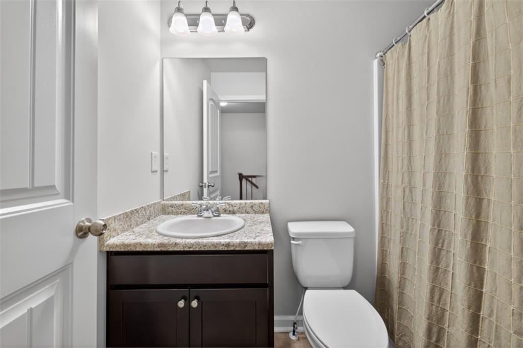 286 Turtle Creek Drive Winder, GA 30680 - Photo 33 of 39 a bathroom with a granite countertop sink toilet and mirror