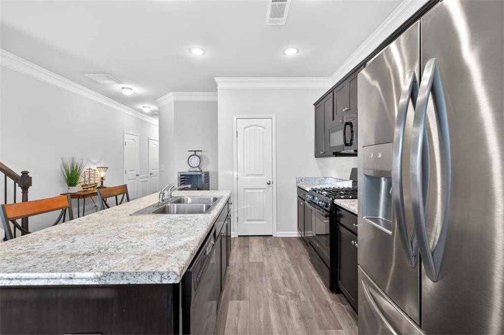 286 Turtle Creek Drive Winder, GA 30680 - Photo 7 of 39 a kitchen with stainless steel appliances granite countertop a sink stove and refrigerator