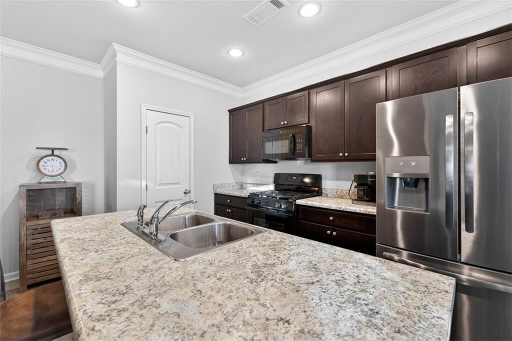 286 Turtle Creek Drive Winder, GA 30680 - Photo 10 of 39 a kitchen with granite countertop a refrigerator and a sink