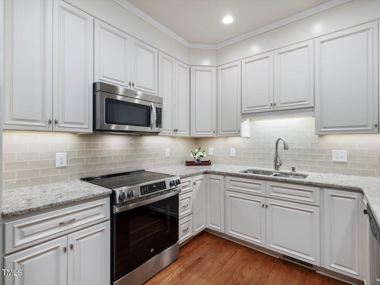 3347 Ridgecrest Court Raleigh, NC 27607 - Photo 13 of 65 a kitchen with granite countertop white cabinets and stainless steel appliances