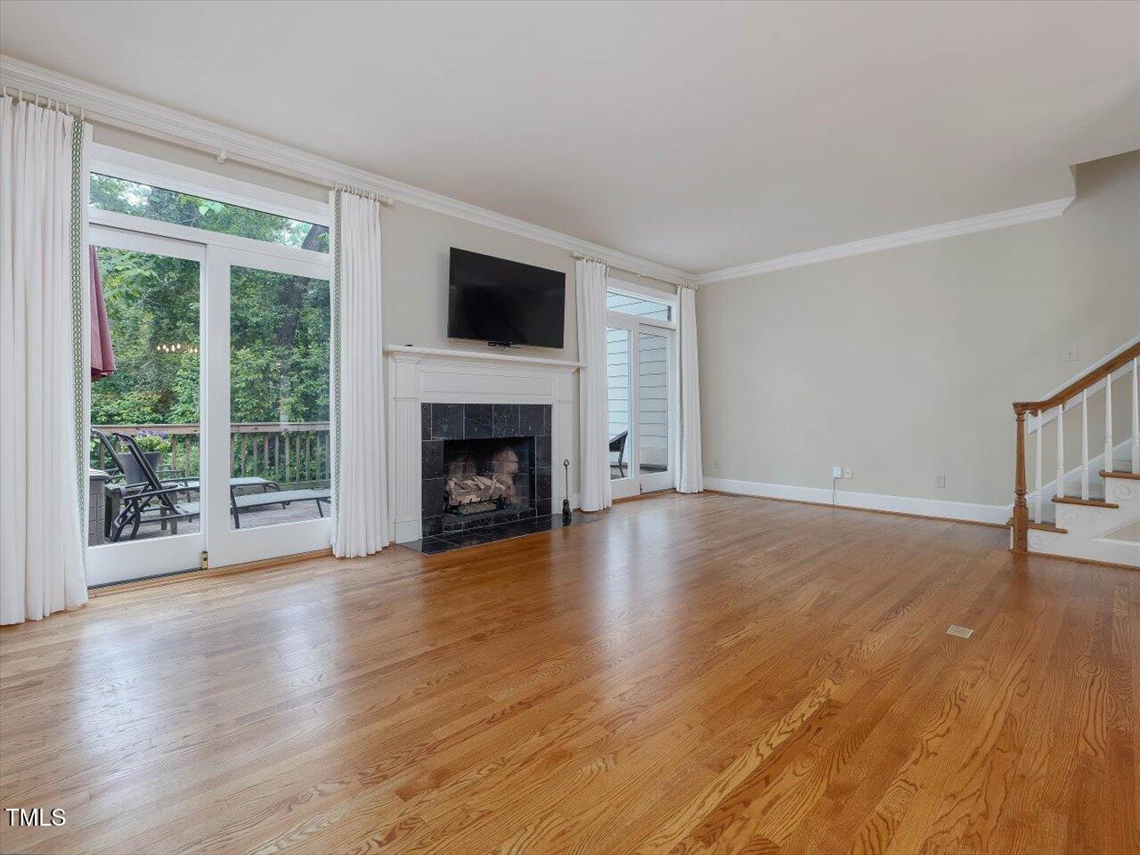 3347 Ridgecrest Court Raleigh, NC 27607 - Photo 22 of 65 a view of empty room with wooden floor and fireplace