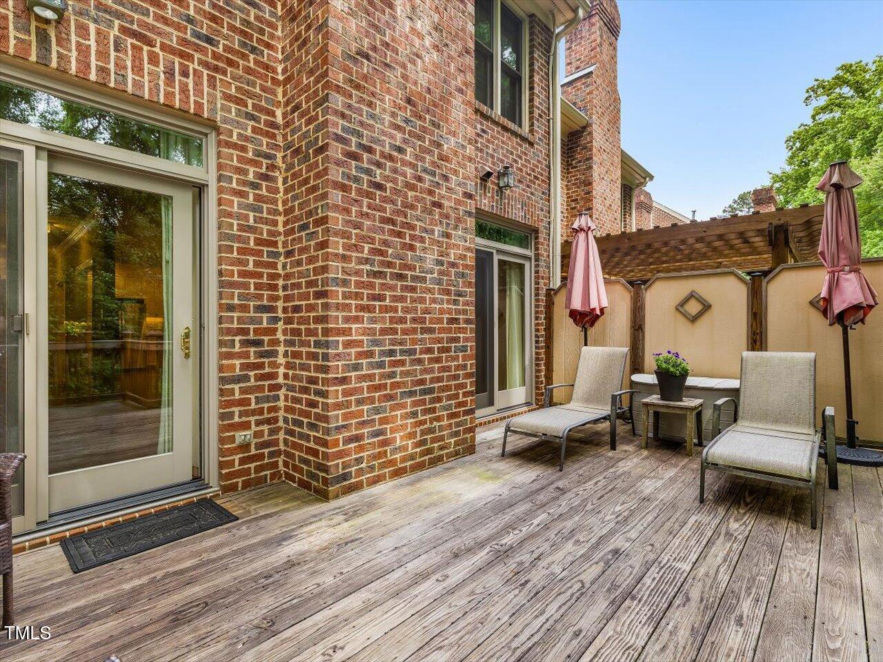 3347 Ridgecrest Court Raleigh, NC 27607 - Photo 29 of 65 a view of a patio with couches and table and chairs with wooden floor and a yard