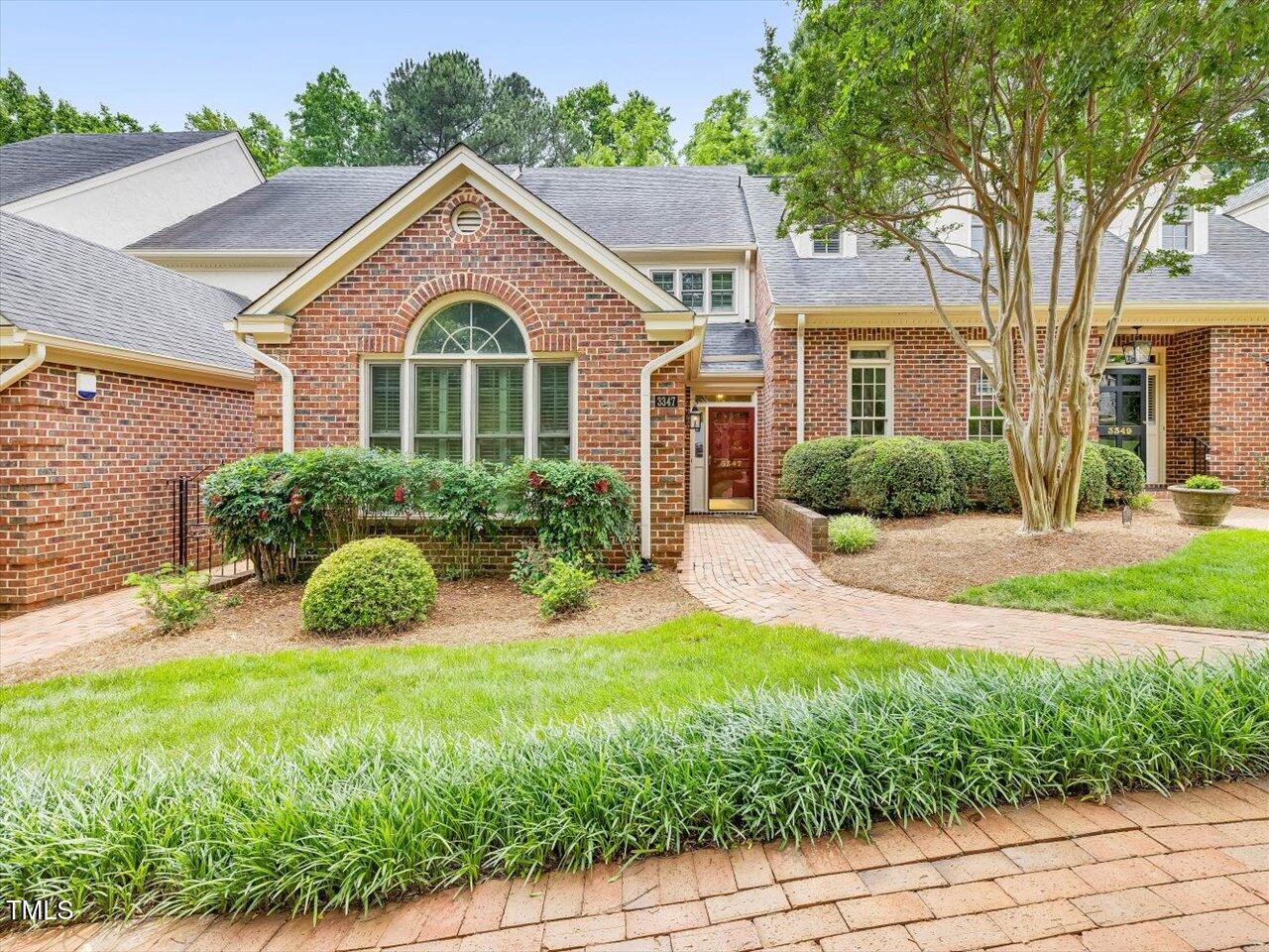 3347 Ridgecrest Court Raleigh, NC 27607 - Photo 2 of 65 a front view of a house with a yard and potted plants