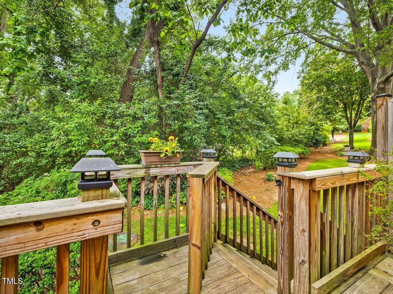 3347 Ridgecrest Court Raleigh, NC 27607 - Photo 30 of 65 a view of a deck with wooden floor barbeque oven and trees