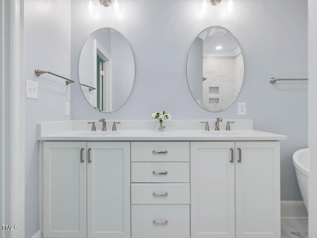 3347 Ridgecrest Court Raleigh, NC 27607 - Photo 45 of 65 a bathroom with a double vanity sink and a mirror