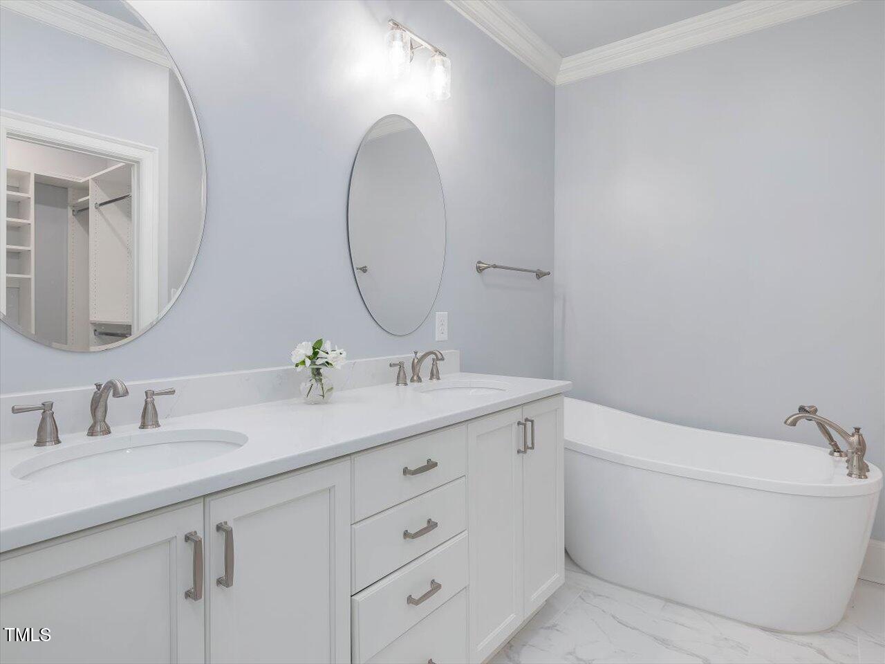 3347 Ridgecrest Court Raleigh, NC 27607 - Photo 46 of 65 a bathroom with a double vanity sink and a mirror