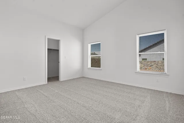 an empty room with windows and closet