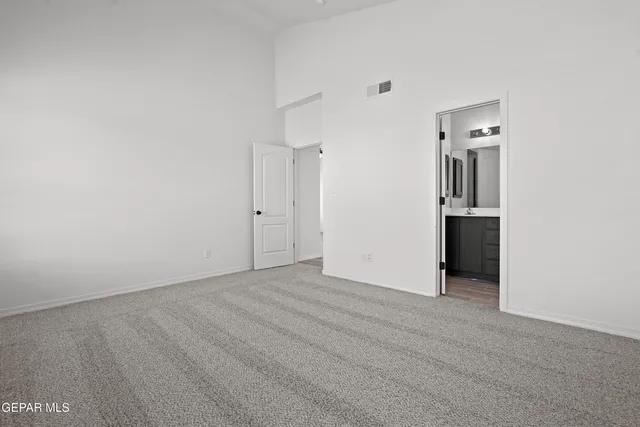an empty room with closet and wooden floor