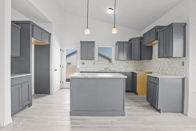 a kitchen with a sink cabinets and wooden floor