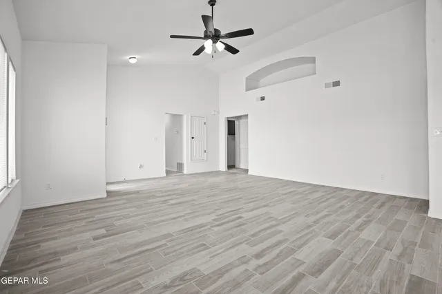 a view of empty room with wooden floor