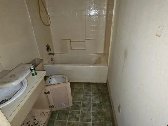 a backyard of a house with table and chairs