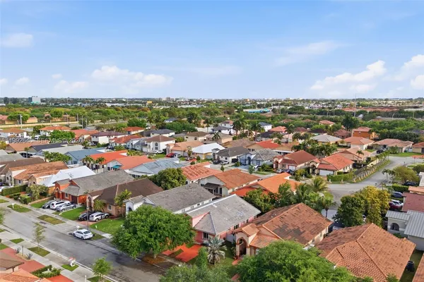 an aerial view of residential houses with outdoor space